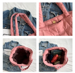 Detail of pink quilted tote bag showing large capacity for tablet and magnetic closure