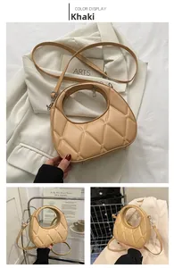 Detailed view of khaki quilted dumpling bag with silver hardware and adjustable strap