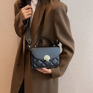 Chic black quilted leather crossbody bag with gold lock buckle and top handle