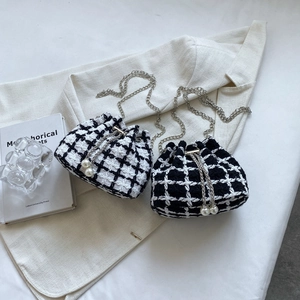 Minimalist tweed drawstring bucket bag with silver chain strap and pearl accents