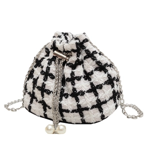 Fashionable tweed bucket bag with black and white plaid pattern and pearl drawstring details