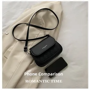 Detailed size comparison of a black quilted saddle bag next to a smartphone
