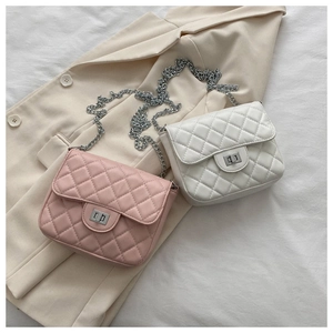 Detailed flat-lay of quilted crossbody bags with metal chains and turn-lock closures