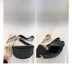 Size comparison and interior layout of the black nylon crescent crossbody tote bag