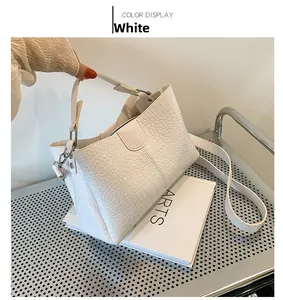 Détail du sac cabas blanc à motif crocodile avec fermoir et bandoulière amovible