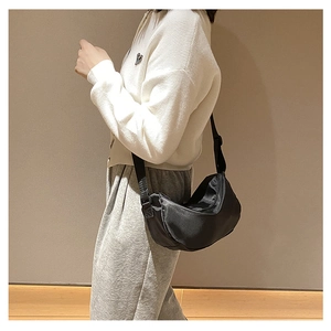 Waterproof nylon half-moon crossbody bag shown on a model for daily casual wear