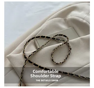 Close-up of elegant gold chain shoulder strap woven with black leather for luxury handbag