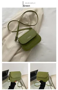 Detail of green quilted matte PU leather crossbody bag with white fashion trend text
