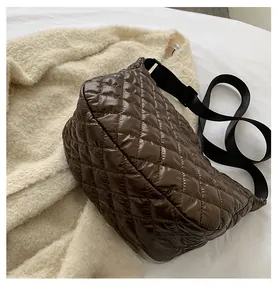 Detail of coffee brown quilted nylon dumpling bag with adjustable black wide strap