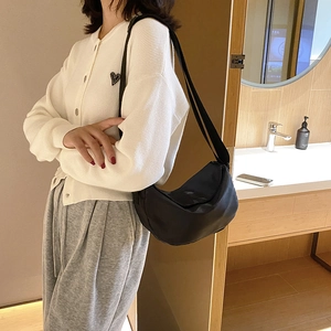 Chic black nylon hobo crossbody bag for women in a stylish indoor setting