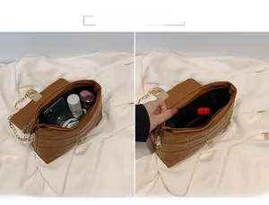 Interior view of brown quilted chain bag showing capacity for phone and cosmetics