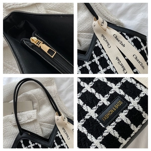 Detail of black and white checkered tweed tote with golden zipper and ribbon trim