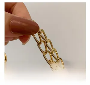 Close-up of bright gold metal chain strap featuring high-polish oval link hardware