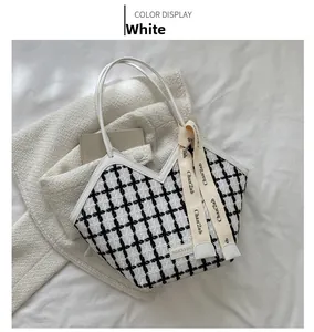 Top view of large black and white checkered tweed tote bag with elegant white handles