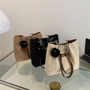 Quilted tote bags in beige, black and brown with chain straps and plush charms