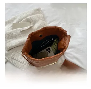 Top view showing the spacious interior of the brown quilted chain shoulder bag