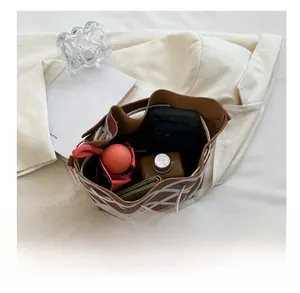 Interior view showing capacity for phone, umbrella, and wallet in bucket bag