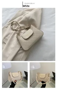Detail view of cream white crossbody bag with checkered pattern and woven strap