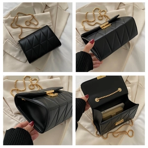 Detail view showing internal storage and golden chain of a black quilted shoulder bag
