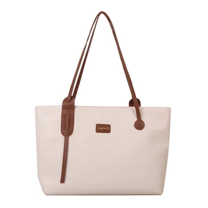 Minimalist beige tote bag with brown handles and quilted diamond texture on white background