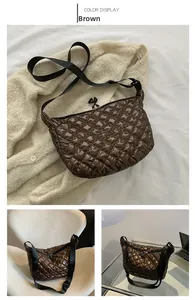 Detailed macro of a brown quilted puffer tote bag with a unique letter A zipper puller