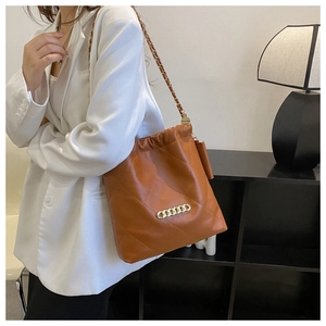 Brown quilted bucket shoulder bag for women with gold chain strap and drawstring closure