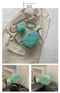 Detail of mint green quilted oval bag with gold chain and camellia floral ornament