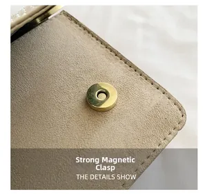 Detail of velvet chain bag showing strong gold magnetic clasp and premium suede texture