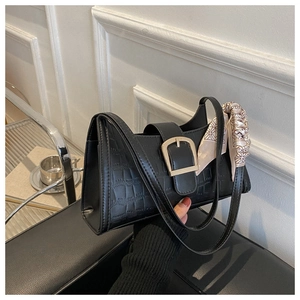 Black crocodile pattern shoulder bag with golden buckle and stylish silk scarf detail