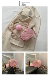 Detail of pink quilted handbag with golden camellia clasp and woven chain strap