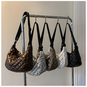 Quilted puffer cloud bags in five colors hanging on a metal rack with black nylon straps