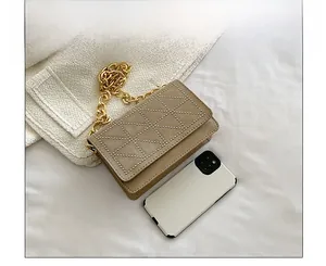 Detail of khaki velvet crossbody bag with studded diamond patterns and gold chain
