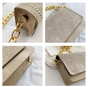 Detail view of khaki velvet crossbody bag with silver studs and chunky gold chain strap
