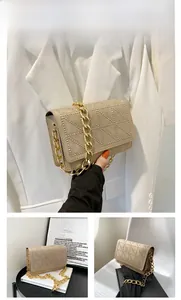 Detail of khaki velvet bag with silver studs, geometric texture and gold chain