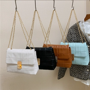 Quilted crossbody chain bag in white, black, brown and blue with gold hardware