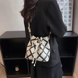Modern minimalist black and white checkered bucket bag with drawstring and leather strap