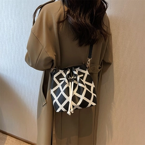 Chic black and white checkered leather drawstring bucket bag for women with gold hardware