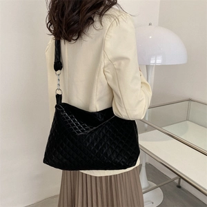 Large black quilted tote bag with diamond lattice pattern for women on casual shoulder