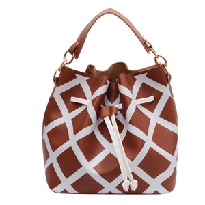 Brown bucket bag with white geometric grid pattern and drawstring closure on white background