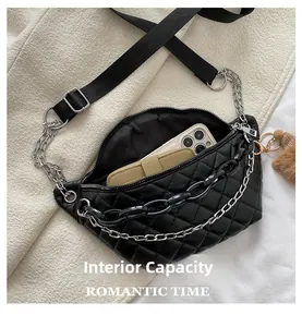 Internal capacity of black quilted waist bag showing space for phone and card holder