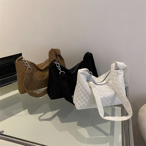 Quilted oversized shoulder bags in brown, black and white with metal chain accents