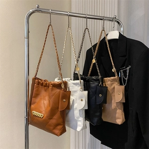 Quilted crossbody chain bags in brown, white, and black with matching mini pouches