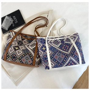 Detail of two bohemian woven tote bags featuring colorful ethnic geometric textures and leather trim