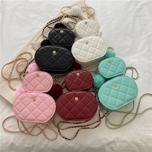 Quilted oval crossbody chain bags with camellia logo and plush charms in five colors
