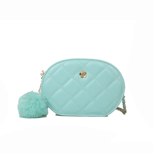 Mint green quilted chain crossbody bag with floral clasp and plush ball charm on white background