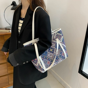 Ethnic style woven tote bag with geometric patterns and white leather shoulder straps