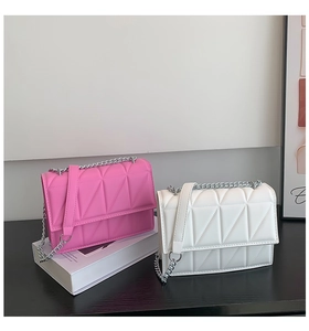 Quilted crossbody bags in pink and white with geometric patterns and silver chain straps