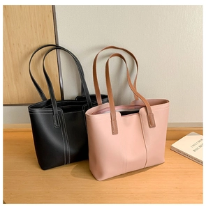 Detail of minimalist black and pink tote bags with contrast stitching on smooth PU leather