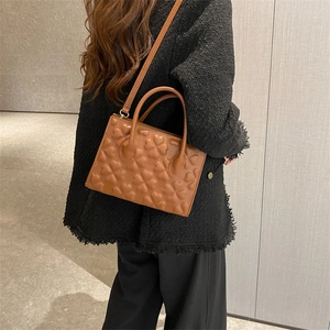 Vintage brown leather crossbody bag with embossed heart pattern for women outfits