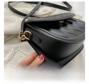 Detail showing the neat stitching and gold hardware on the vintage matte black purse